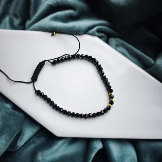 Melna ar zelta krāsas furnitūru aproce